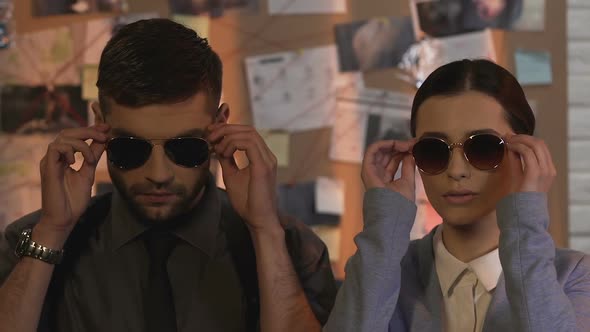 Professional Detectives of Private Investigation Service Putting on Sunglasses