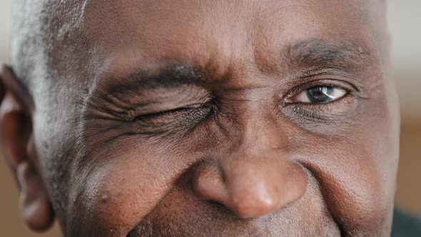 Close Up Part Male Face Happy Elderly African American Man Smiling with Friendly Dark Black Eyes