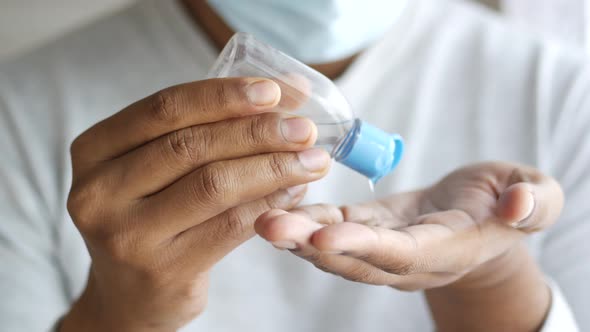 Men with Face Mask Using Sanitizer Liquid for Preventing Corona Virus