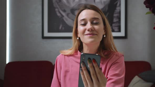 Happy Woman Talking on Smartphone By Video Chat at Home