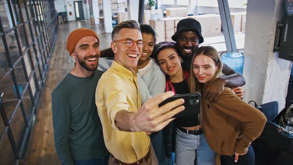 Casual Business Team Taking Collective Photo on Cellphone During Break in Office Smiling at Camera