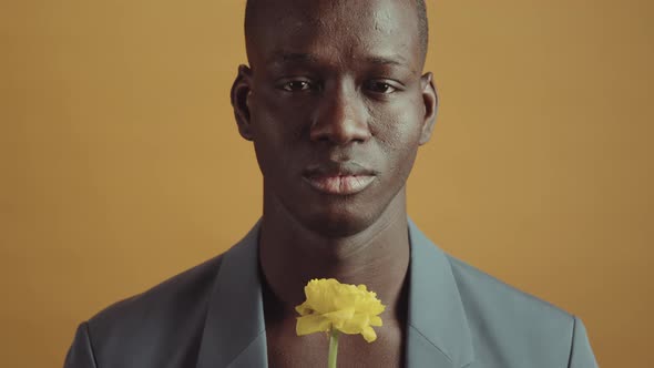 Black Man Holding Yellow Flower