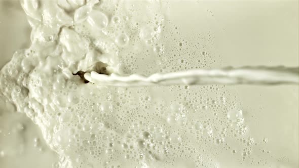 A Stream of Milk Flows with Splashes and Air Bubbles