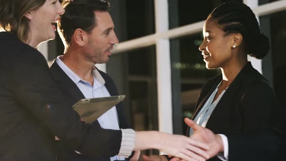 Group of businesspeople discussing together over digital tablet