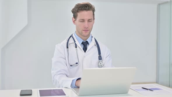 Young Doctor Saying No with Finger Sign in Office