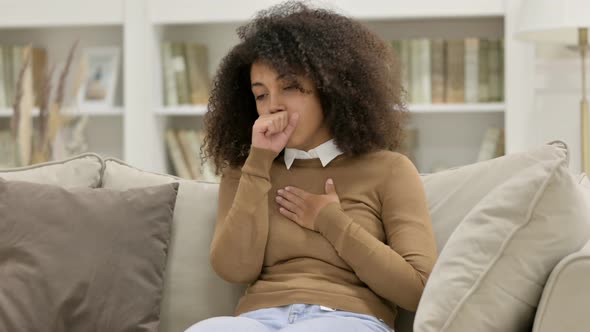 Sick Young African Woman Coughing on Sofa