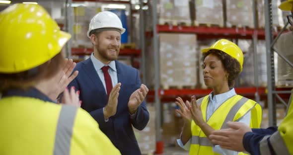 Warehouse Owner Holding Staff Meeting Discussing Successful Results