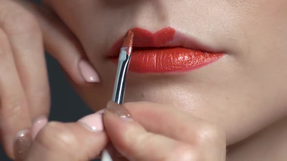 Visagist Using Lipstick Brush.