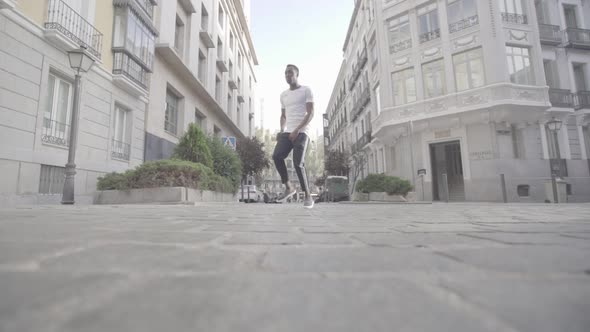 African man dancing and singing on street