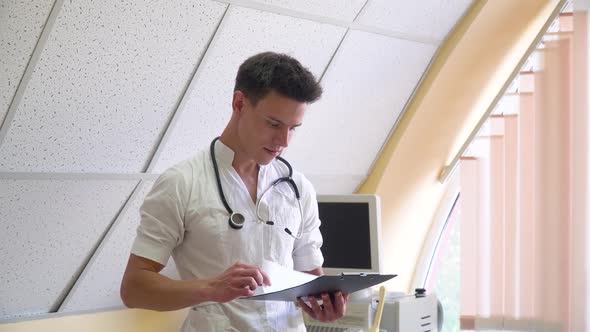 Young Doctor Examines the Patient's Medical History