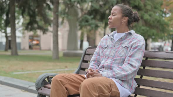 Angry African Woman Feeling Frustrated While Sitting Outdoor on Bench