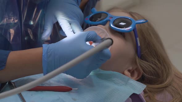 Little Girl with Oral Dilator at Dentist's Appointment