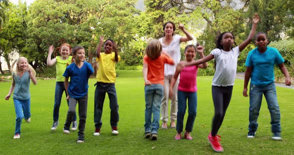 Teacher and pupils dancing together