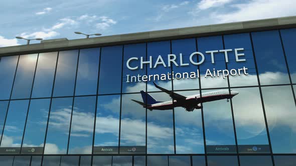 Airplane landing at Charlotte North Carolina, USA airport mirrored in terminal