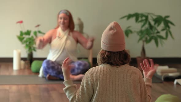 Woman Following Instructor for Eagle Pose