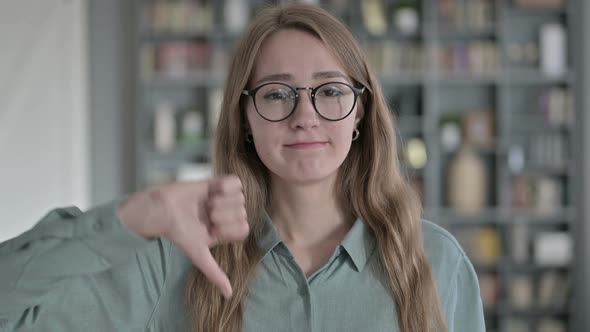 Portrait of Ambitious Woman Showing Thumbs Down