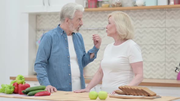 Old Couple Working on Smartphone in Kitchen