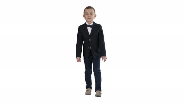 Little Boy in a Costume with a Bow Tie Walking on White Background.