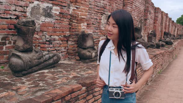 Japanese backpacker female enjoy her journey at amazing landmark in traditional city.