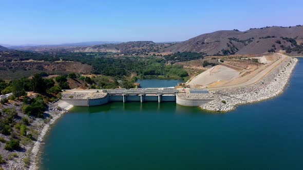 Aerial fly over shot of Lake Cachuma and the Bradbury Dam near Santa Barbara Ca. with clear blue sky