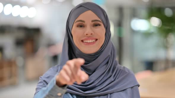 Serious Young Arab Woman Pointing at the Camera