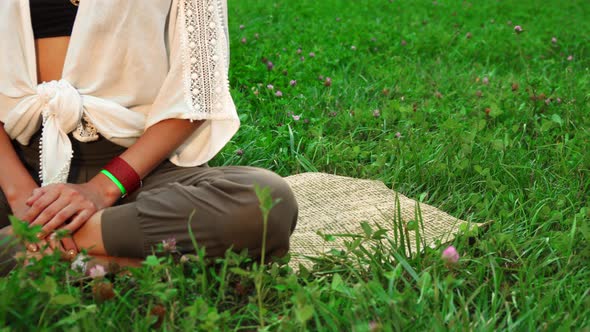 The Young Lady Is Sitting on the Mat and Doing Yoga