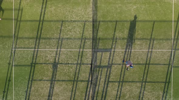 View From the Height of the Tennis Court Where People Warm Up Before the Game