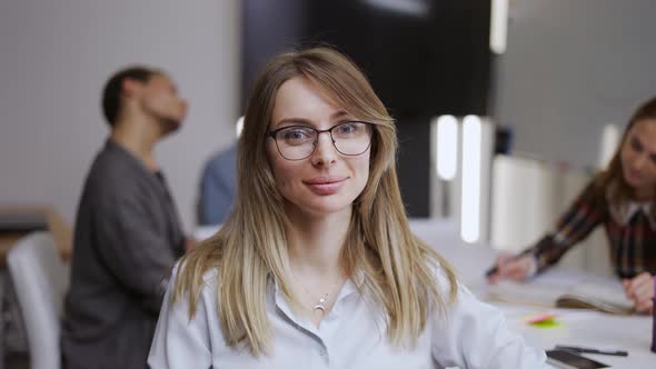 Smiling Caucasian Girl Intern Standing at Modern Office Coworking Space