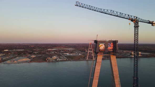 Flying around Suspension tower of Gordie Howe brigde during evening sun, Orbit drone shot, Detroit -