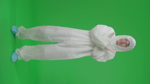 Full Body Of Man Wear Protective Uniform Ppe And Showing Stop Sign In The Green Screen Studio