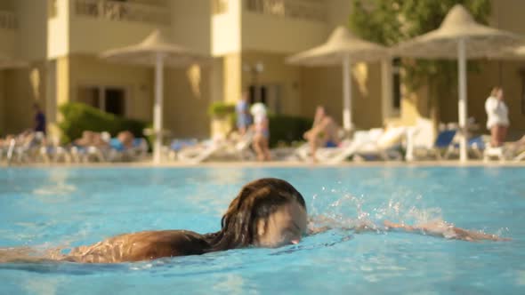 The Athletic Girl Swims in the Pool