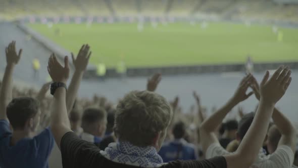 Fans at the Stadium During the Match. Slow Motion.