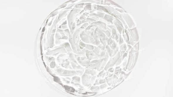 Rotation of Transparent Cosmetic Gel Fluid with Bubbles in a Glass Bowl of Petri