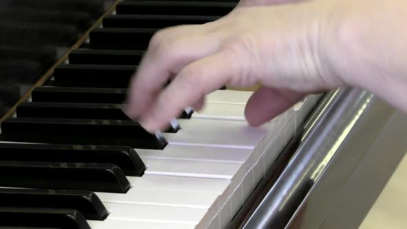 The pianist's hands on the piano keys.