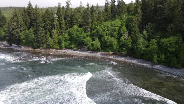 Drone orbiting around Sombrio beach on Vancouver Island's wild west coast. A few campers with tents