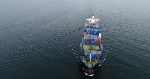 Aerial view of cargo container ship vessel import export container sailing.