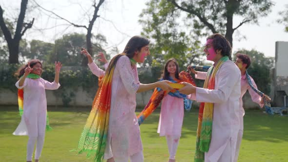 Indian man gifts a sweet box to his partner on Holi occasion