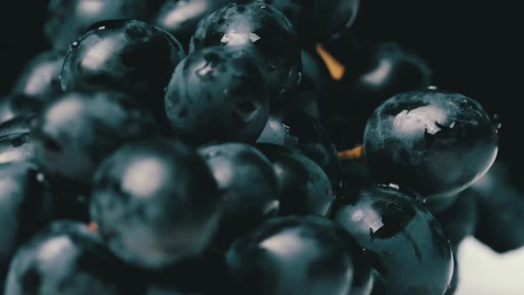 A Bunch of Blue Wet Grapes Spinning Slowly