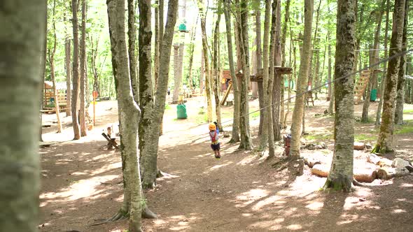 Boy Quickly Slides Down the Zip Line in the Adventure Park