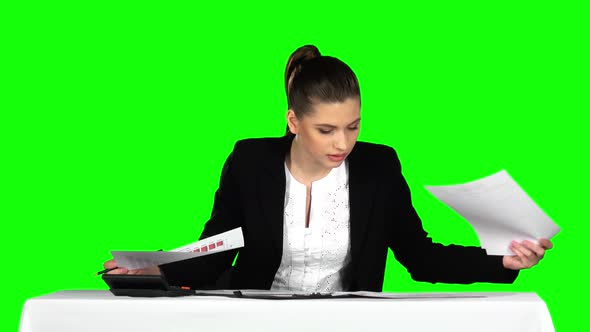 Young Businesswoman Overwhelmed By Too Much Paperwork in Office. Green Screen