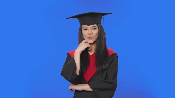 Portrait of Female Student in Cap and Gown Graduation Listening Attentively Nodding Pointing Finger