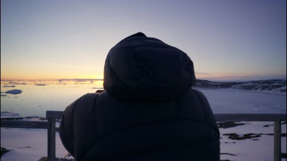 Photographer Focussing Long Lens Of Camera To Shoot Sunset