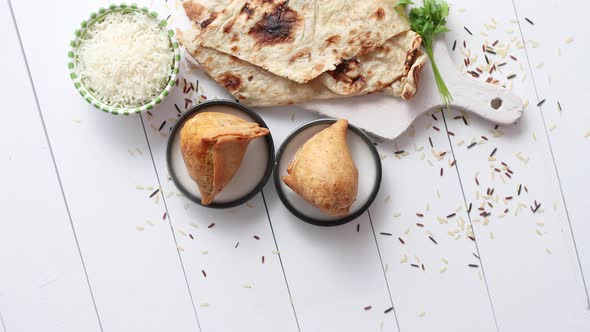 Traditional Indian Food Snack Samosa Served in a Plate on a White Wooden Table