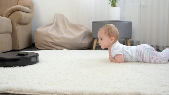 Robot Vacuum Cleaner Rides to Cute Baby Boy Lying on Carpet in Living Room