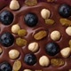 Chocolate with hazelnuts, blueberry, raisin top view, rotate - VideoHive Item for Sale