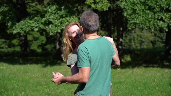 Mature Happy Couple Dancing in the Park