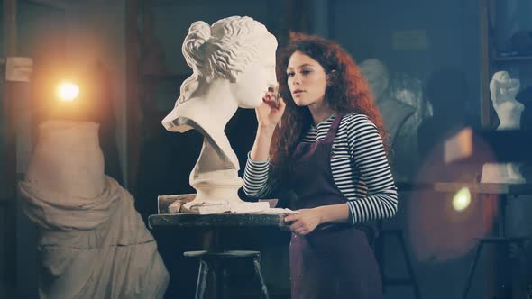 Female Artist is Carefully Brushing a Gypsum Sculpture