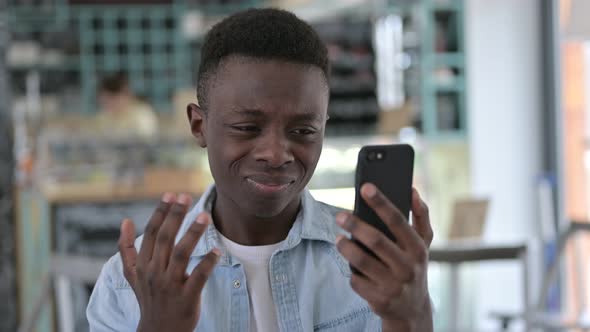 African Man reacting to Failure on Smartphone