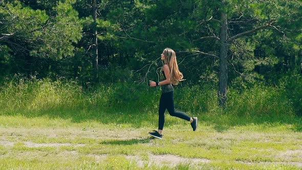 Slow Motion, Side Shot: Young Woman Goes in for Sports in the Morning