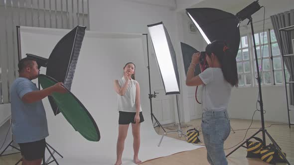 Behind The Scenes On Photo Shoot: Beautiful Asian Model Poses For A Photographer, She Takes Photos